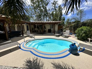 Lounge poolside in the private backyard. Heated pool can be enjoyed year-round.