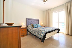 En-suite master bedroom with king size bed and access to the balcony
