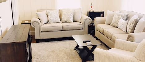 Living room with plenty of storage, seating and flat screen tv