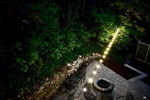 A cozy patio tucked between the house and the hill