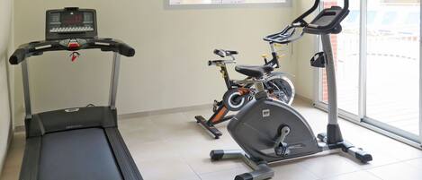 Exercise Machine, Building, Exercise Equipment, Elliptical Trainer, Stationary Bicycle, Gym, Floor, Flooring, Machine