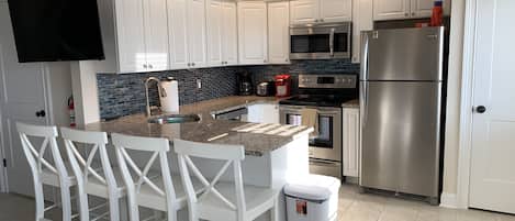 Recently renovated kitchen with granite countertop and stainless steel appliance