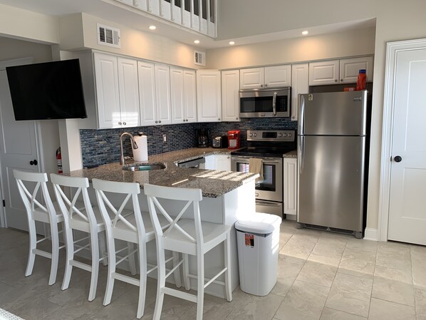 Recently renovated kitchen with granite countertop and stainless steel appliance