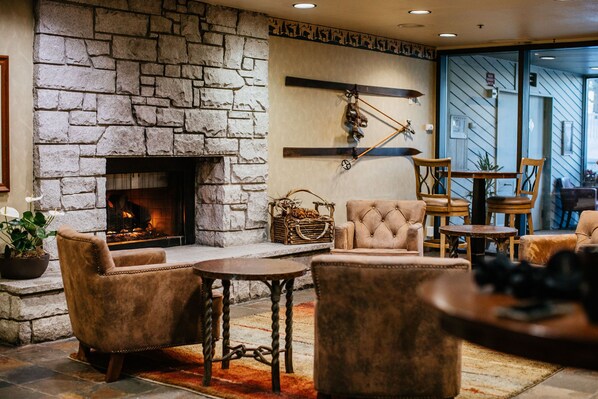 Cozy up by the crackling fireplace in a warm and inviting lounge perfect for unwinding after an adventure-filled day.