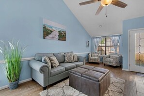 Spacious living room area with a sleeper sofa.