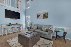 Enjoy watching your favorite shows on the mounted flat-screen TV.
