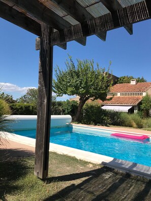 Shady pool cabin with outdoor shower, summer kitchen and drinks fridge.