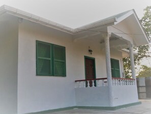 East side view of entrance to The Bungalow and porch.