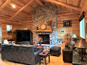 Living room with wood burning fireplace ample TV seating and bar