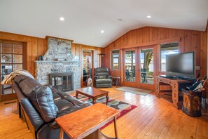 Cozy cottage living room with a lake view and attached to the sunroom.  