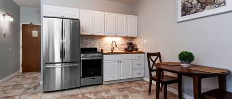 Modern appliances and ample storage in sleek kitchen design.