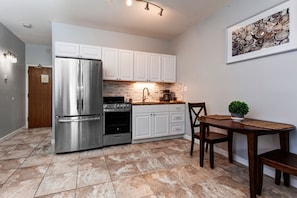 Modern appliances and ample storage in sleek kitchen design.