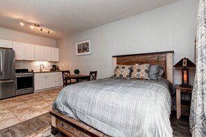Charming studio with queen bed, dining table, and fully equipped kitchen.