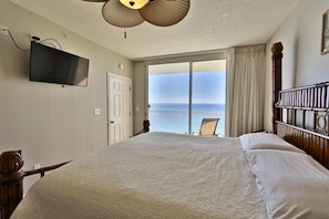 Master bedroom with king sized bed and access to balcony