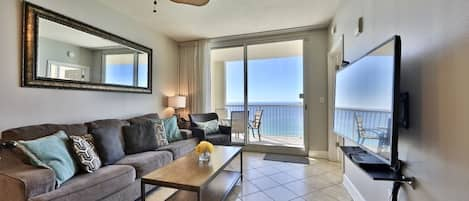 Living room with sleeper sofa and access to balcony