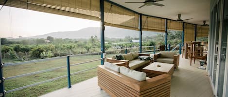 Outdoor furniture on the large decking overlooking canopy of orchard farms