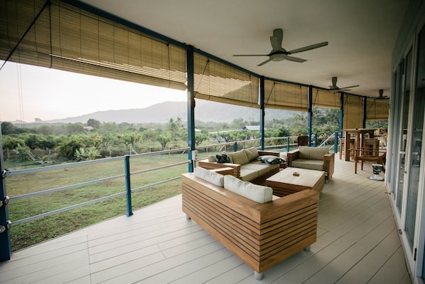 Outdoor furniture on the large decking overlooking canopy of orchard farms