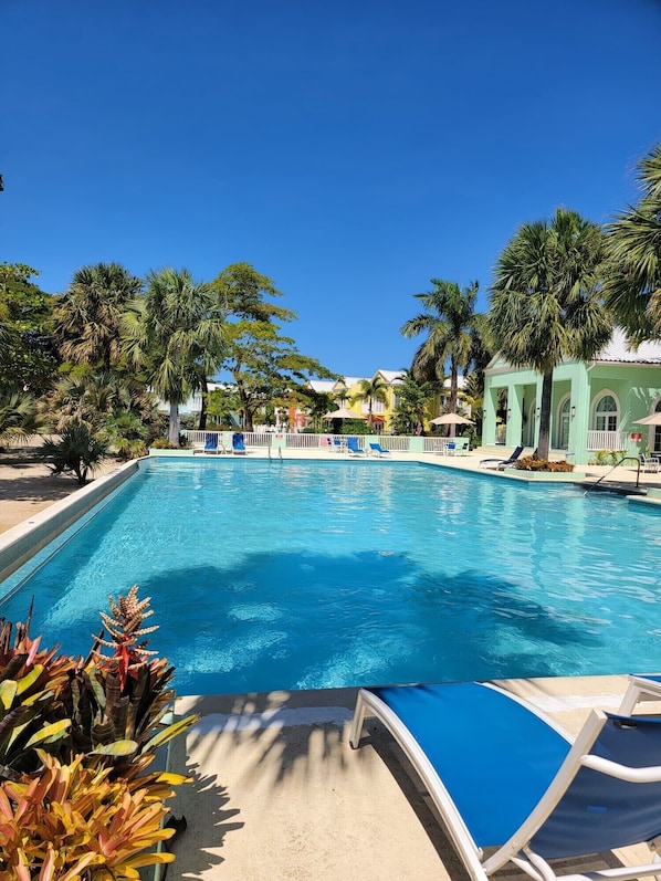 Located in Little Bay Country Club
Step unto a private beach . Steps to the pool