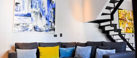 Welcome to our Brand New Casa SOHO.  Here is our spacious living area with art.