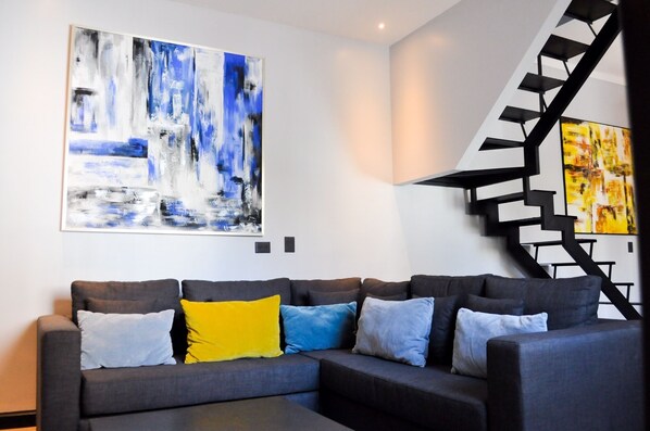 Welcome to our Brand New Casa SOHO.  Here is our spacious living area with art.