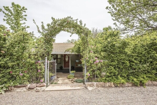 Enter through the arch to reach the front porch and entry door.