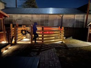 A cowboy welcomes you at the gate to the hot tub. The backyard is fully fenced-in for Fido or for your children to play.