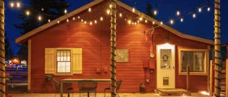 Farmhouse - a true 1930's cabin. View of the backyard, perfect for outdoor living with a 4-person hot tub, Weber gas grill, fire pit, full fenced-in backyard and The Bunk House filled with history and farmhouse collections from around the region.