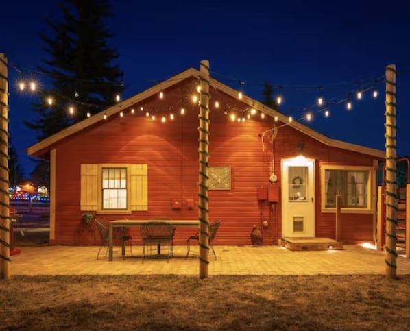 Farmhouse - a true 1930's cabin. View of the backyard, perfect for outdoor living with a 4-person hot tub, Weber gas grill, fire pit, full fenced-in backyard and The Bunk House filled with history and farmhouse collections from around the region.