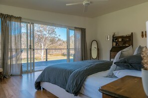 Main bedroom opens onto expansive deck with bush views.