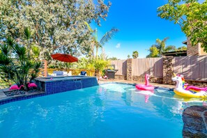 Attached jacuzzi spills over into your large heated pool.