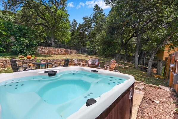 Private hot tub in fenced yard.