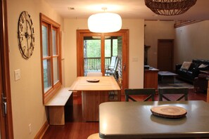 Dining room area next to outside deck overlooking mountains.