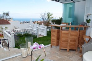 Views of the lavender-lined terraced garden and the ocean from the 
Sunroom