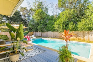 Pool w/deck, loungers, patio furniture and charcoal grill. 