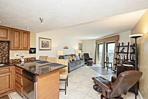 Living room features a NEW Queen sleeper sofa, 2 chairs with ottomans.