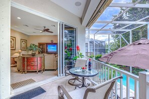 Main level screened lanai overlooks the pool and beautiful Siesta Key landscapes.