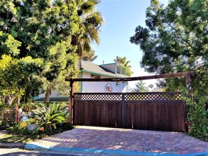 Front gate. Park to left of gate and walk into courtyard through small gate. 