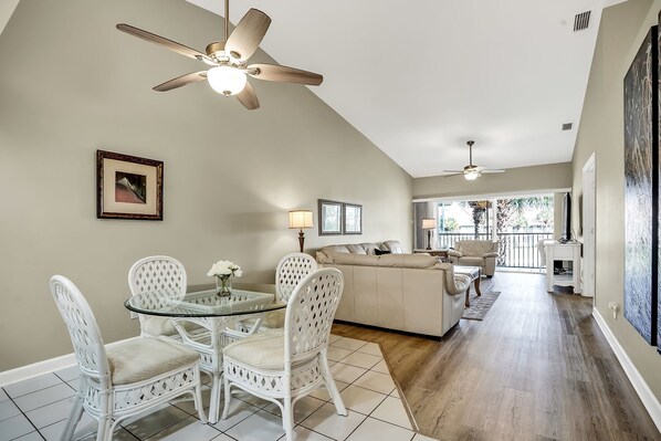 Dining area, Living room w glass doors to large lanai that overlooks pond.