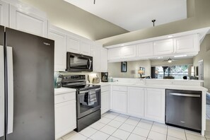 Fully equipped kitchen with newer Whirlpool appliances.
