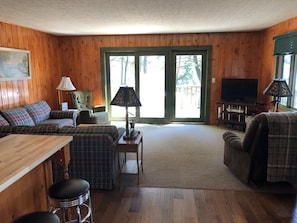 Living room with sliding glass door facing lake