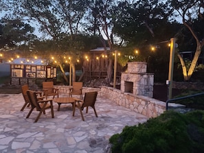 Enjoy the breezy summer nights with some wine and spirits on the stone patio.