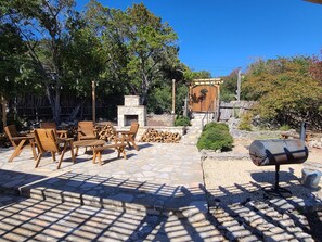 Large open patio with a wood fireplace to light up at night.