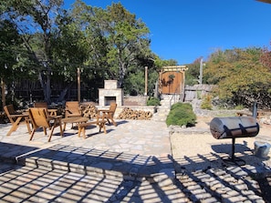 Large open patio with a wood fireplace to light up at night.