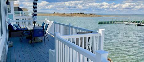 Your bayfront deck with dining table and comfortable daybed for relaxing.