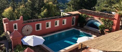 The swimming pool courtyard and surrounding countryside