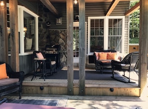 Large covered porch with BBQ and rocking chairs.