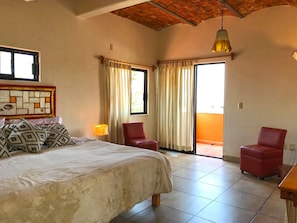 The comfy king size bed in the secure and bright third story master bedroom. 