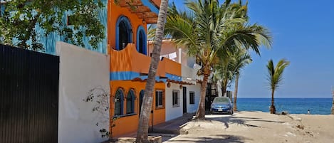 The Faro is the second and third floors of the orange building and at the beach.