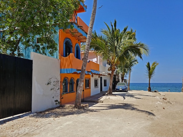 The Faro is the second and third floors of the orange building and at the beach.