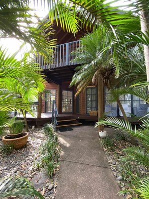 Leafy entry with keyless front door.